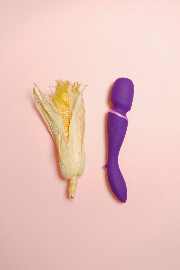 our-services-1 A creative still life concept featuring an ear of corn and a purple vibrator on a pastel background.